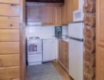 a kitchen with wooden cabinets and an open refrigerator